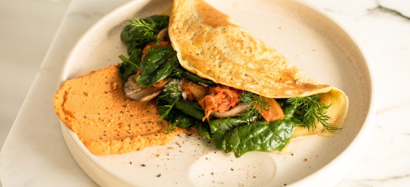 omelette with fresh greens and bacon, with toast, on plate